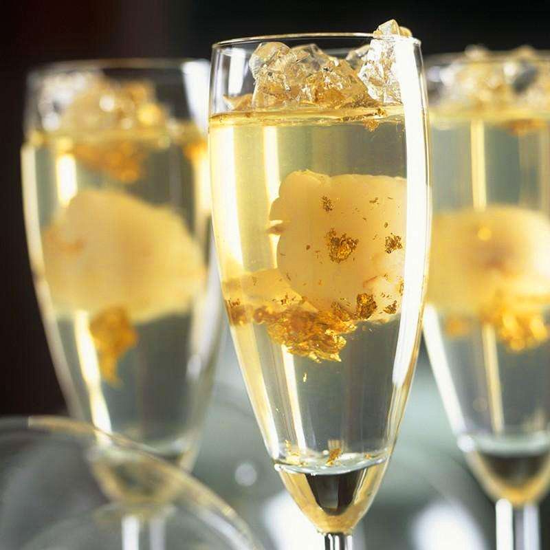 Gold flakes in white wine